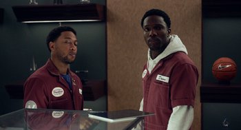 Movie still from “House Party” (2023), directed by Calmatic – A couple of men standing next to each other in a room; Medium shot, Over the shoulder angle