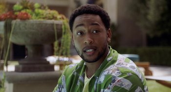 Movie still from “House Party” (2023), directed by Calmatic – A person wearing a shirt and tie; Close Up shot, Over the shoulder angle