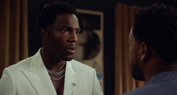 Movie still from “House Party” (2023), directed by Calmatic – A man in a white suit talking to another man in a white suit; Close Up shot, Over the shoulder angle