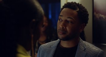 Movie still from “House Party” (2023), directed by Calmatic – A person wearing a suit jacket; Close Up shot, Over the shoulder angle
