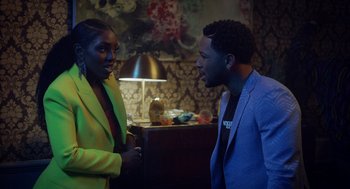 Movie still from “House Party” (2023), directed by Calmatic – A man and a woman talking to each other in a room; Medium shot, Over the shoulder angle