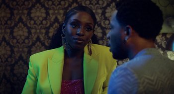 Movie still from “House Party” (2023), directed by Calmatic – A woman in a yellow jacket talking to a man in a green jacket; Close Up shot, Over the shoulder angle