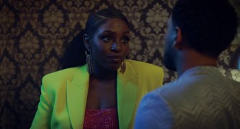 Movie still from “House Party” (2023), directed by Calmatic – A woman in a yellow jacket is talking to a man; Close Up shot, Over the shoulder angle