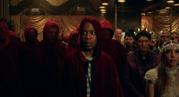 Movie still from “House Party” (2023), directed by Calmatic – A group of men in red robes and hoods; Medium shot, Low angle