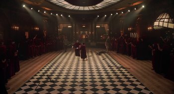 Movie still from “House Party” (2023), directed by Calmatic – A group of people standing around in a room with checkered floors; Extreme Wide shot, High angle