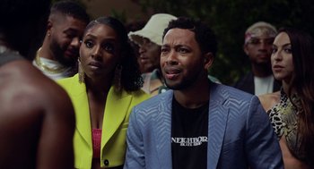 Movie still from “House Party” (2023), directed by Calmatic – A man and a woman standing next to each other in front of a crowd; Close Up shot, Over the shoulder angle