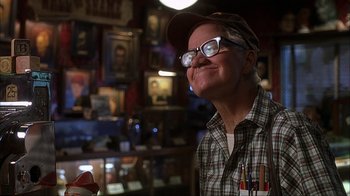 Movie still from “House of 1000 Corpses” (2003), directed by Rob Zombie – An older man wearing glasses and a hat; Close Up shot, Low angle