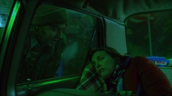 Movie still from “House of 1000 Corpses” (2003), directed by Rob Zombie – A man and a woman sleeping in the back of a car; Medium shot, Over the shoulder angle