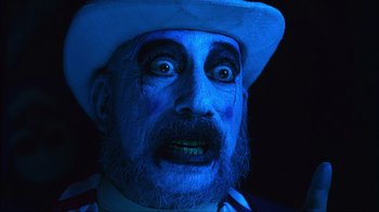 Movie still from “House of 1000 Corpses” (2003), directed by Rob Zombie – A person with a clown makeup; Close Up shot, Low angle