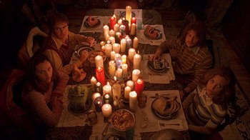 Movie still from “House of 1000 Corpses” (2003), directed by Rob Zombie – A group of people sitting around a dinner table with lit candles; Medium shot, Overhead angle