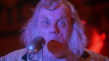 Movie still from “House of 1000 Corpses” (2003), directed by Rob Zombie – An old man with a strange look on his face; Close Up shot, Low angle
