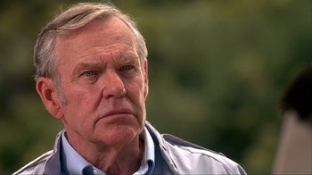 Movie still from “House of 1000 Corpses” (2003), directed by Rob Zombie – An older man is looking into the distance; Close Up shot, Low angle