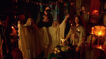 Movie still from “House of 1000 Corpses” (2003), directed by Rob Zombie – A group of people dressed up in costumes; Wide shot, Low angle