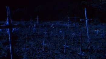 Movie still from “House of 1000 Corpses” (2003), directed by Rob Zombie – Many crosses in a field at night; Extreme Wide shot, High angle