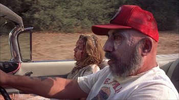 Movie still from “House of 1000 Corpses” (2003), directed by Rob Zombie – A man and a woman riding in the back of a boat; Close Up shot, Low angle
