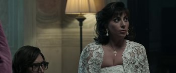 Movie still from “House of Gucci” (2021), directed by Ridley Scott – A person wearing a dress; Close Up shot, Over the shoulder angle
