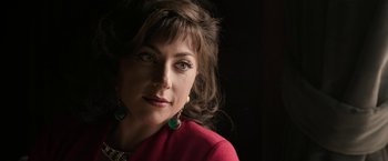 Movie still from “House of Gucci” (2021), directed by Ridley Scott – A person wearing a red jacket; Close Up shot, Over the shoulder angle