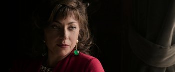 Movie still from “House of Gucci” (2021), directed by Ridley Scott – A person wearing a red jacket; Close Up shot, High angle