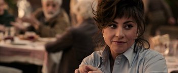 Movie still from “House of Gucci” (2021), directed by Ridley Scott – A person wearing a blue shirt; Close Up shot, Over the shoulder angle