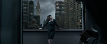 Movie still from “House of Gucci” (2021), directed by Ridley Scott – A woman in a black dress standing on a balcony; Wide shot, Low angle