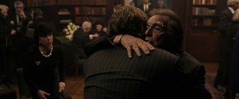 Movie still from “House of Gucci” (2021), directed by Ridley Scott – Two people hugging each other in a room; Medium shot, Over the shoulder angle