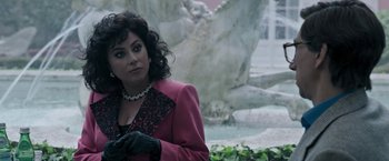 Movie still from “House of Gucci” (2021), directed by Ridley Scott – A woman in a pink coat and black gloves; Close Up shot, Over the shoulder angle