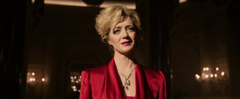 Movie still from “House of Gucci” (2021), directed by Ridley Scott – A woman in a red dress with a necklace; Close Up shot, Low angle
