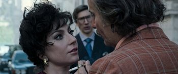 Movie still from “House of Gucci” (2021), directed by Ridley Scott – A man and a woman looking into each others eyes; Close Up shot, Over the shoulder angle