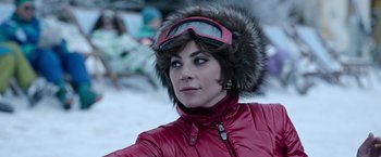 Movie still from “House of Gucci” (2021), directed by Ridley Scott – A person wearing a red jacket; Close Up shot, Over the shoulder angle