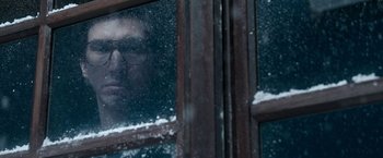 Movie still from “House of Gucci” (2021), directed by Ridley Scott – A man looking out of a window with snow on the ground; Close Up shot, Over the shoulder angle