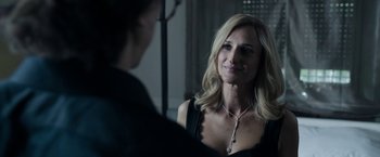 Movie still from “House of Gucci” (2021), directed by Ridley Scott – A beautiful blonde woman wearing a black dress; Close Up shot, Over the shoulder angle