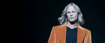 Movie still from “House of Gucci” (2021), directed by Ridley Scott – A woman in a black shirt and a brown jacket; Medium shot, Low angle