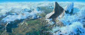 Movie still from “Ice Age: Continental Drift” (2012), directed by Michael Thurmeier – An aerial view of a mountain range with snow on it's tops; Extreme Wide shot, High angle