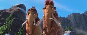 Movie still from “Ice Age: Continental Drift” (2012), directed by Michael Thurmeier – A couple of woolly mammoths standing next to each other on top of a hill; Close Up shot, Low angle
