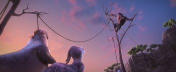 Movie still from “Ice Age: Continental Drift” (2012), directed by Michael Thurmeier – A scene with a monkey hanging from a tree; Wide shot, Low angle