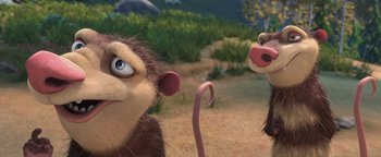 Movie still from “Ice Age: Continental Drift” (2012), directed by Michael Thurmeier – Two animated monkeys in a field with trees in the background; Close Up shot, Low angle
