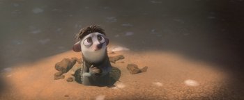 Movie still from “Ice Age: Continental Drift” (2012), directed by Michael Thurmeier – An animated character sitting on the ground in the sand; Medium shot, High angle
