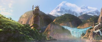 Movie still from “Ice Age: Continental Drift” (2012), directed by Michael Thurmeier – A statue in the middle of a valley with a mountain in the background; Extreme Wide shot, Low angle