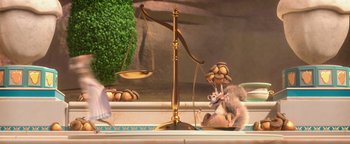 Movie still from “Ice Age: Continental Drift” (2012), directed by Michael Thurmeier – A rat sitting on top of a scale in front of a tree; Wide shot, High angle