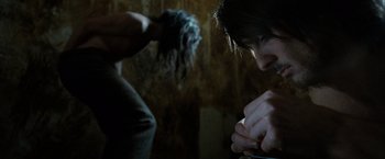 Movie still from “Hunger” (2008), directed by Steve McQueen – A person with a brush in their hand and another person with a brush in their hand; Medium shot, Over the shoulder angle