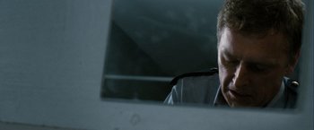 Movie still from “Hunger” (2008), directed by Steve McQueen – A man sitting in front of a mirror; Close Up shot, Over the shoulder angle