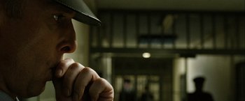 Movie still from “Hunger” (2008), directed by Steve McQueen – A man with a baseball cap and a baseball glove; Close Up shot, Over the shoulder angle