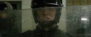 Movie still from “Hunger” (2008), directed by Steve McQueen – A man wearing a black helmet and a black jacket; Close Up shot, Low angle