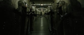 Movie still from “Hunger” (2008), directed by Steve McQueen – A hallway with a bunch of people standing in it; Wide shot, High angle