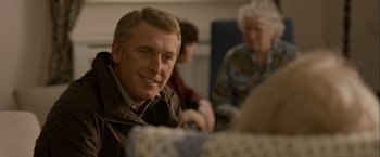 Movie still from “Hunger” (2008), directed by Steve McQueen – A person sitting at a table; Close Up shot, Over the shoulder angle