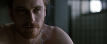 Movie still from “Hunger” (2008), directed by Steve McQueen – A person with a beard; Close Up shot, Over the shoulder angle