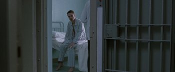 Movie still from “Hunger” (2008), directed by Steve McQueen – A man sitting on a bed in a hospital room; Medium shot, High angle