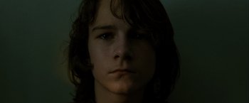 Movie still from “Hunger” (2008), directed by Steve McQueen – A person with long brown hair; Close Up shot, Low angle