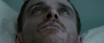 Movie still from “Hunger” (2008), directed by Steve McQueen – A man's face with blue eyes; Extreme Close Up shot, Low angle
