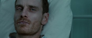 Movie still from “Hunger” (2008), directed by Steve McQueen – A man's face as he lies in a bed; Close Up shot, Low angle